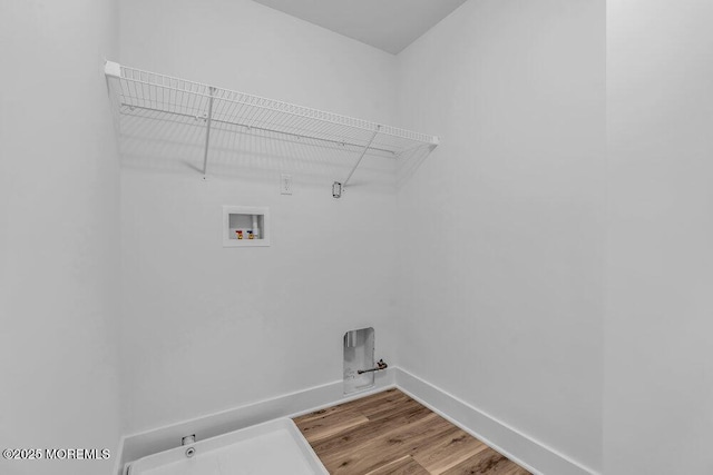 washroom with gas dryer hookup, hookup for a washing machine, and hardwood / wood-style flooring