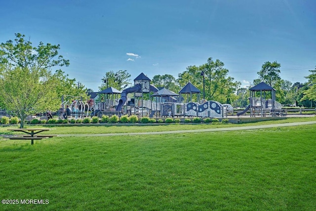 view of property's community featuring a yard and a playground