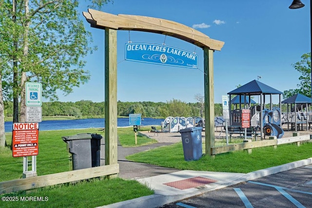 view of home's community with a playground and a water view