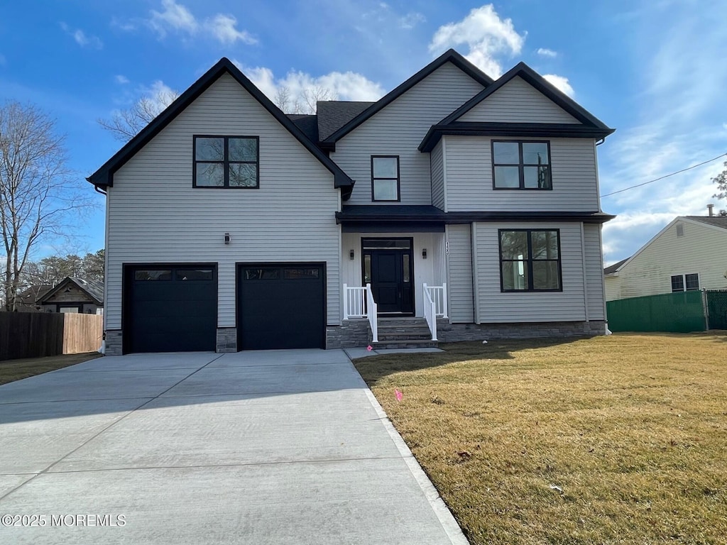 view of front facade with a garage and a front yard