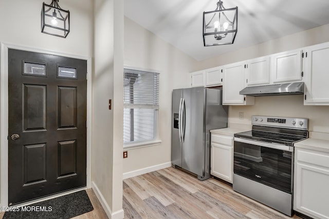 kitchen with lofted ceiling, white cabinetry, light wood-type flooring, pendant lighting, and stainless steel appliances