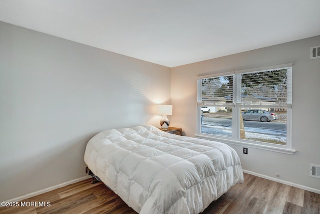 bedroom with hardwood / wood-style flooring