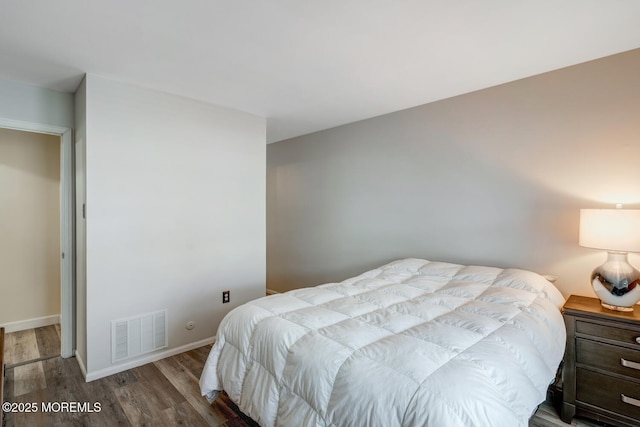 bedroom with hardwood / wood-style flooring