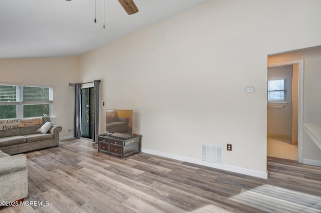 living room featuring ceiling fan, high vaulted ceiling, and light wood-type flooring