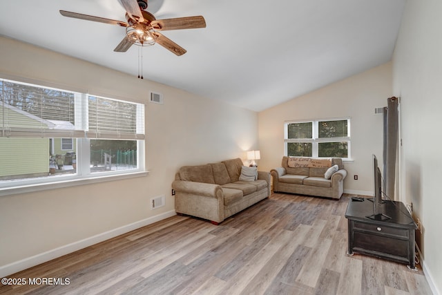 living room with light hardwood / wood-style flooring, vaulted ceiling, and ceiling fan