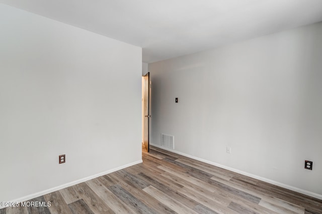 spare room with light hardwood / wood-style floors