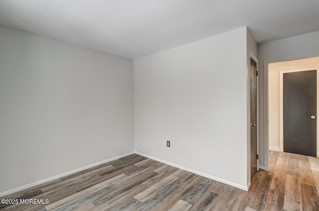 spare room featuring wood-type flooring