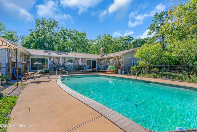 view of pool featuring a patio