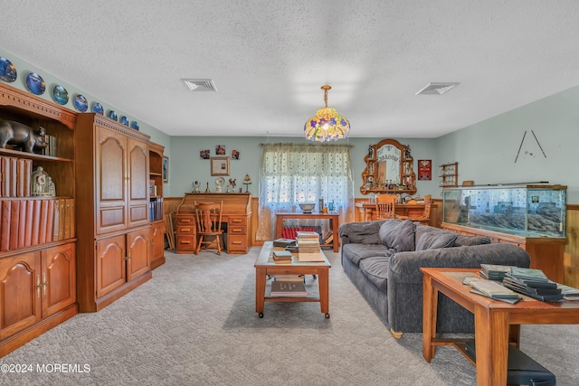 carpeted living room with a textured ceiling