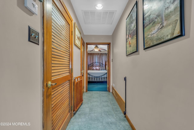 hall featuring light tile patterned floors