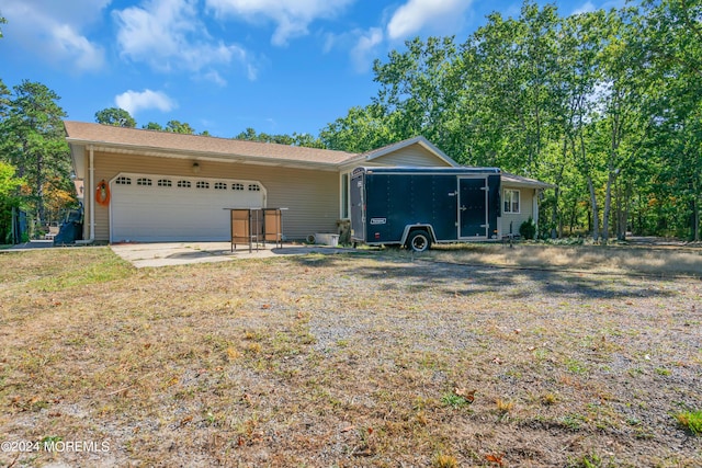 ranch-style home with a garage and a front lawn