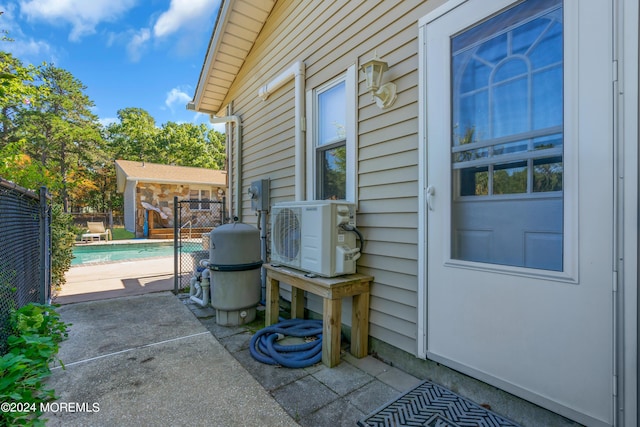 view of patio / terrace featuring an outbuilding and ac unit