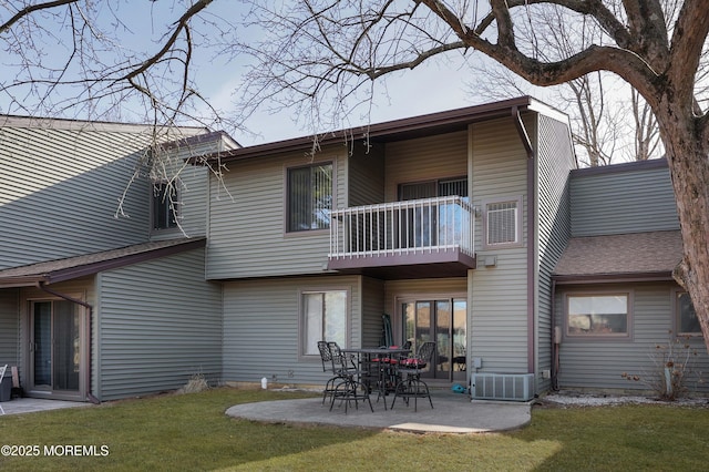 back of house featuring cooling unit, a yard, a patio area, and a balcony