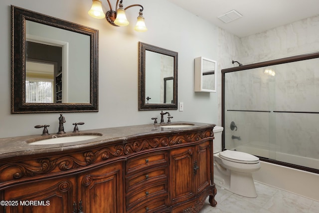 full bathroom with a notable chandelier, enclosed tub / shower combo, vanity, and toilet