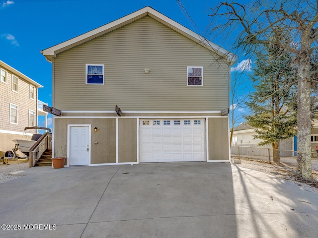 rear view of property with a garage