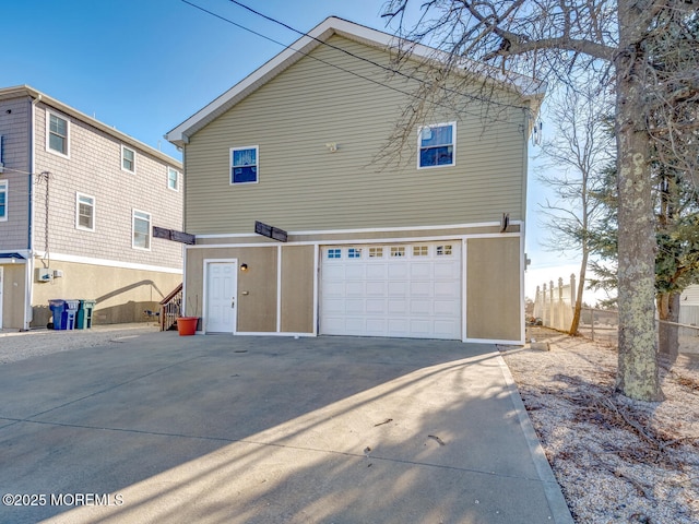 back of property featuring a garage