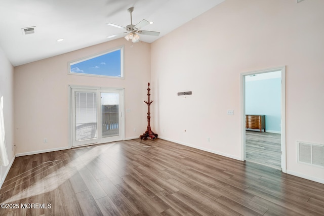 unfurnished living room with wood-type flooring, ceiling fan, and high vaulted ceiling