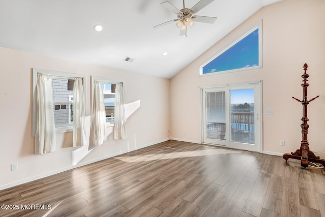 unfurnished living room with ceiling fan, lofted ceiling, and light hardwood / wood-style floors