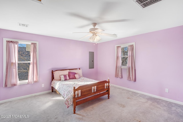 bedroom with light carpet, electric panel, and ceiling fan