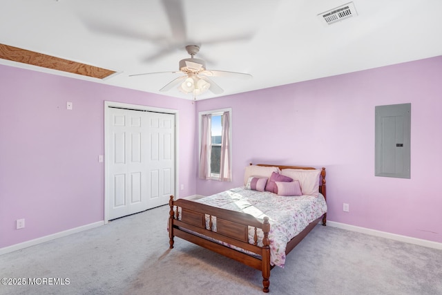 carpeted bedroom featuring electric panel, ceiling fan, and a closet