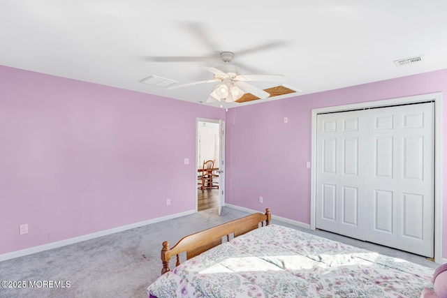 carpeted bedroom with ceiling fan and a closet