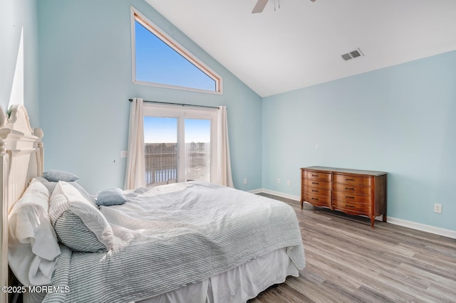 bedroom featuring ceiling fan, high vaulted ceiling, light hardwood / wood-style floors, and access to outside