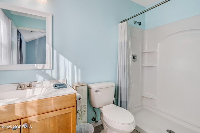 bathroom with vanity, toilet, and a shower with shower curtain