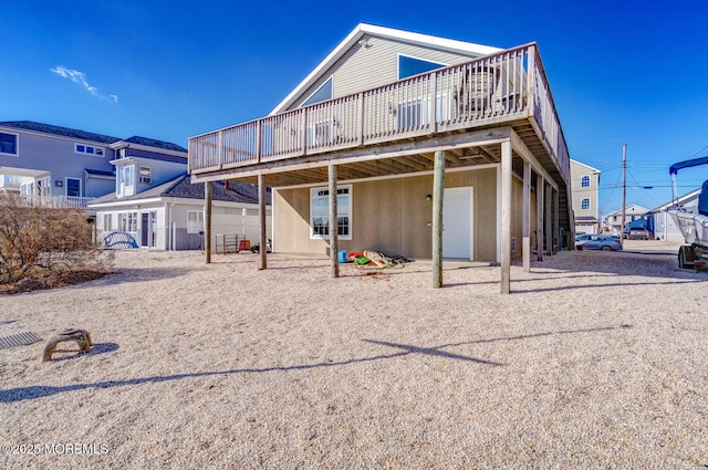 back of house with a wooden deck