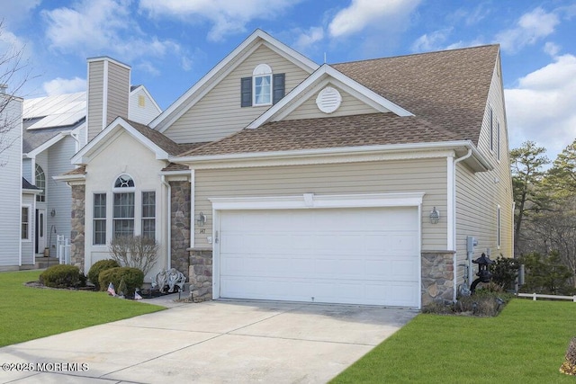 view of front of home with a garage and a front lawn