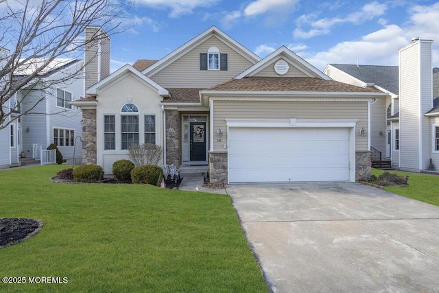 view of front of home with a garage and a front lawn