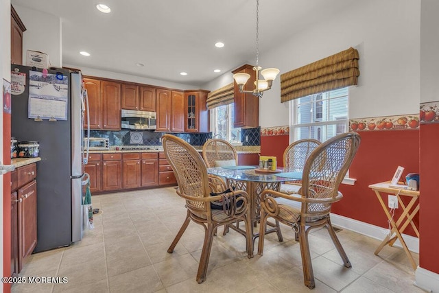 dining room with a chandelier and light tile patterned floors