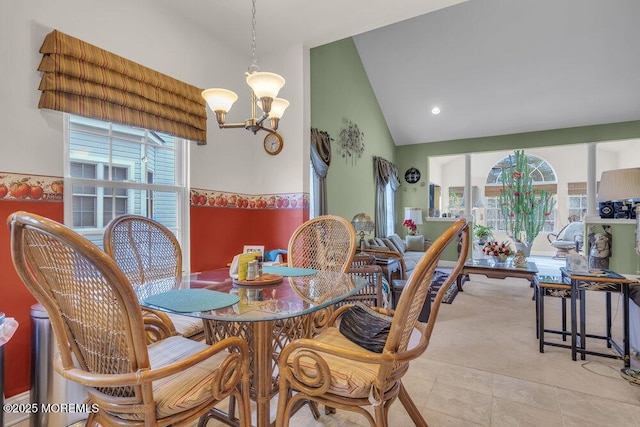 dining area featuring an inviting chandelier and vaulted ceiling