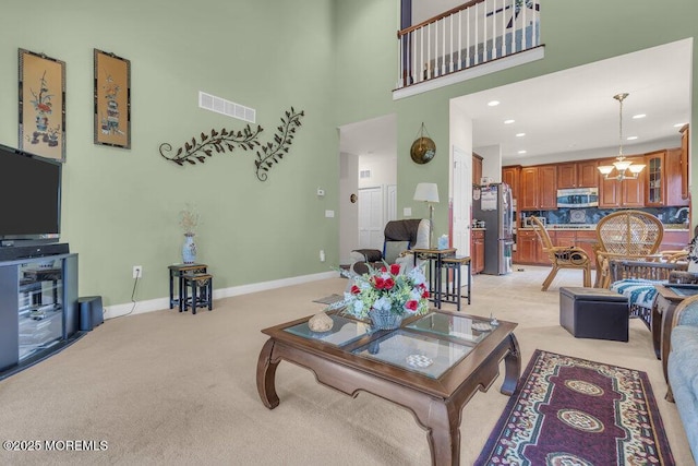 carpeted living room with a towering ceiling