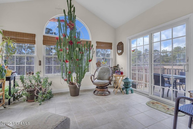 sunroom / solarium featuring vaulted ceiling and a healthy amount of sunlight