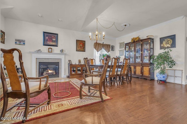 dining space featuring crown molding, dark wood-type flooring, and a notable chandelier