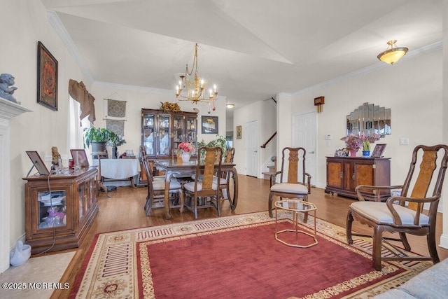 living room featuring crown molding, wood-type flooring, and a chandelier