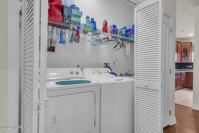 washroom with wood-type flooring and separate washer and dryer