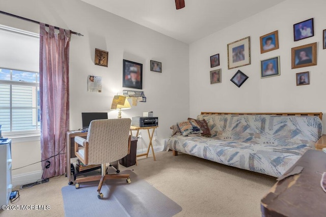 carpeted office space featuring ceiling fan