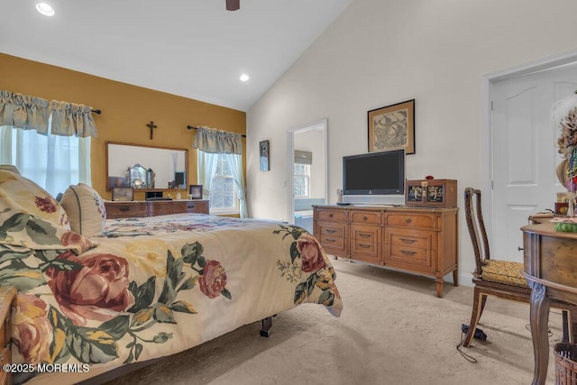 carpeted bedroom featuring high vaulted ceiling and ceiling fan