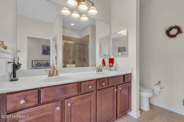 bathroom featuring tile patterned floors, vanity, toilet, and an enclosed shower