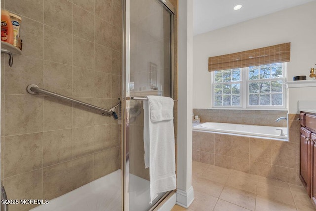 bathroom featuring vanity, tile patterned flooring, and separate shower and tub