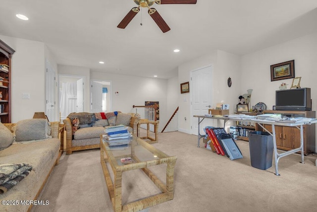 living room featuring light colored carpet and ceiling fan