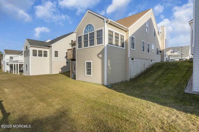 rear view of property featuring a yard