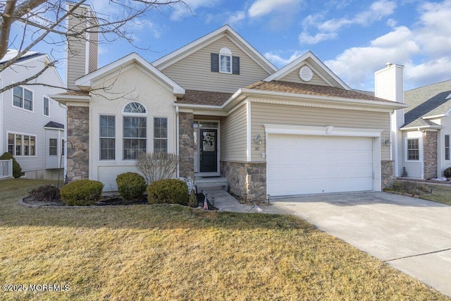 view of front of house with a garage and a front lawn