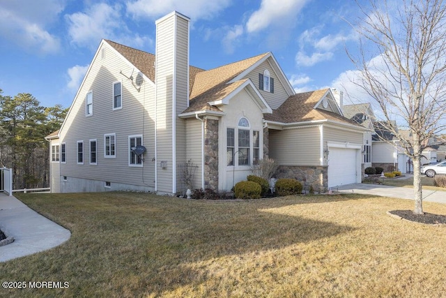 view of front facade featuring a garage and a front lawn