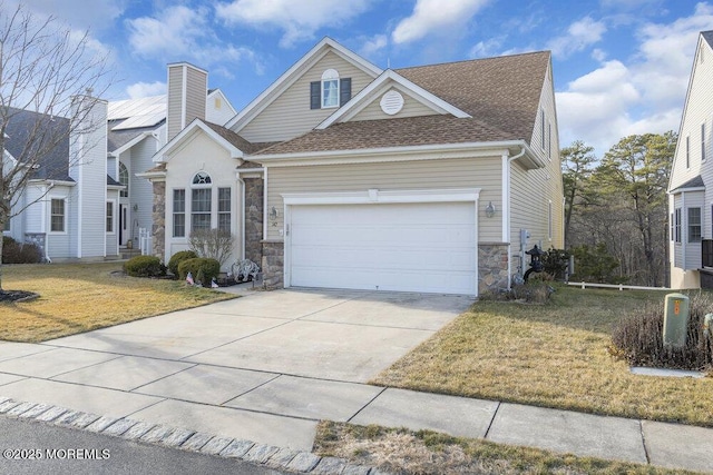 front of property featuring a garage and a front lawn