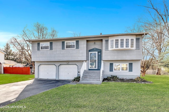 bi-level home with a garage and a front yard