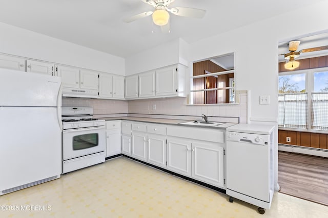 kitchen with sink, white appliances, ceiling fan, baseboard heating, and white cabinetry