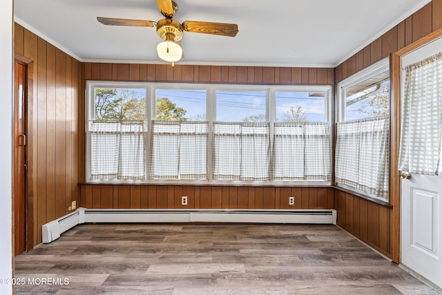 unfurnished sunroom with ceiling fan and baseboard heating