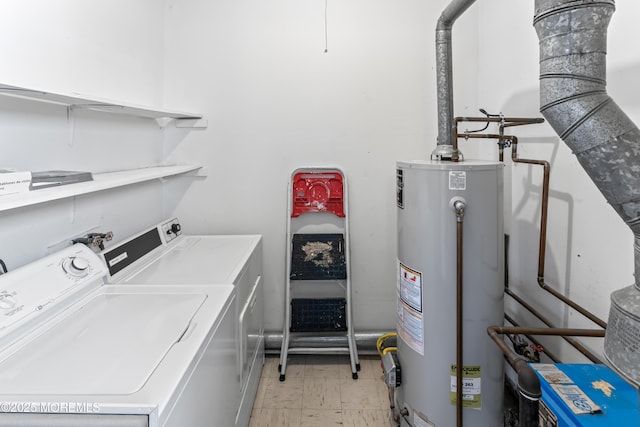 clothes washing area featuring gas water heater and washing machine and clothes dryer